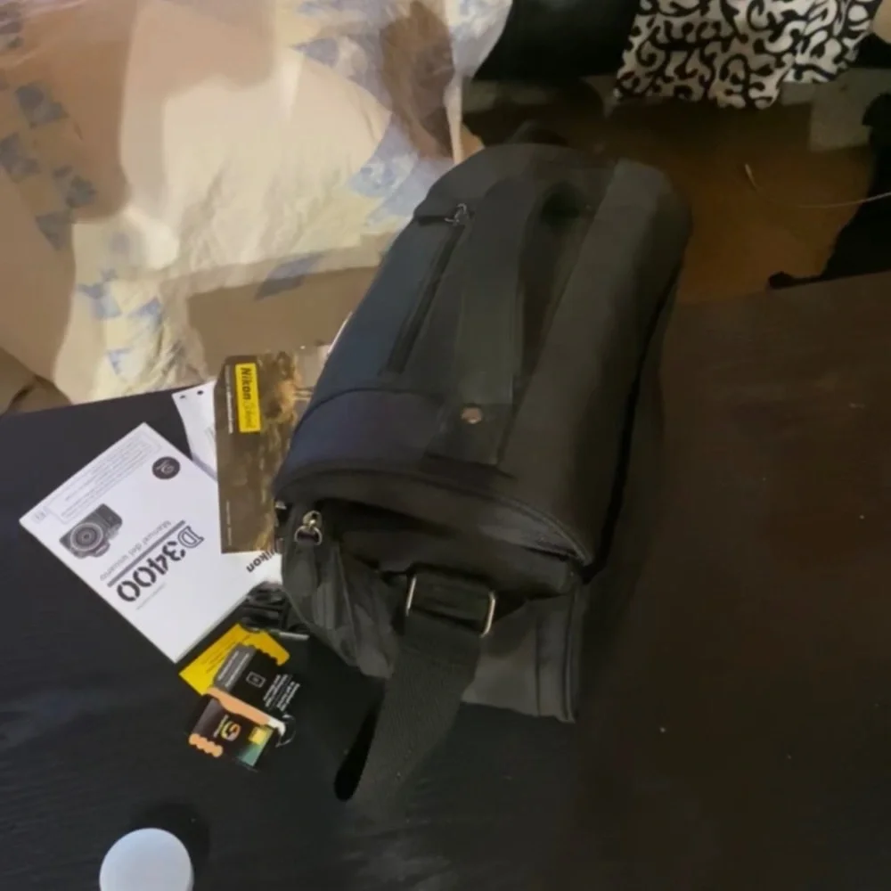 Nikon D3400. Comes with camera, lenses, camera case, battery charger, and tripod